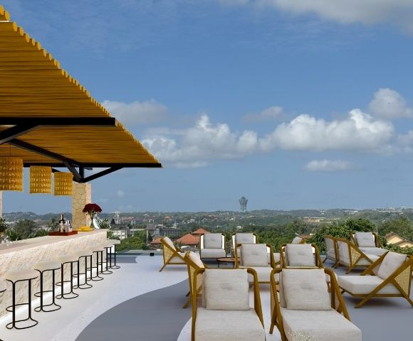 Open-air rooftop bar with lounge seating, bar stools, and panoramic views under a clear blue sky