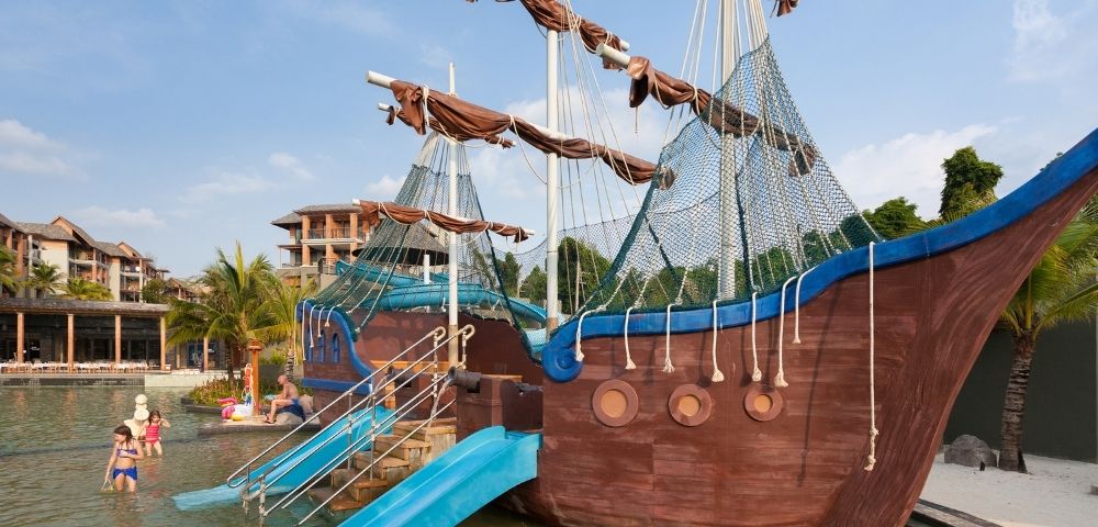 Children's water play area featuring a pirate ship structure and slides