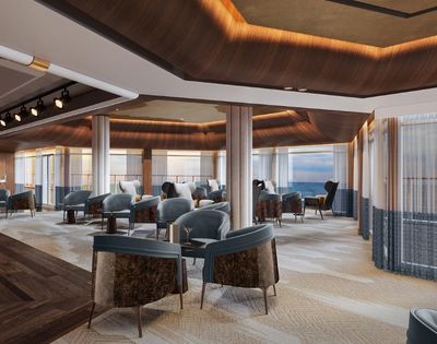Luxurious lounge area with plush seating, a bar, and panoramic ocean views through floor-to-ceiling windows.