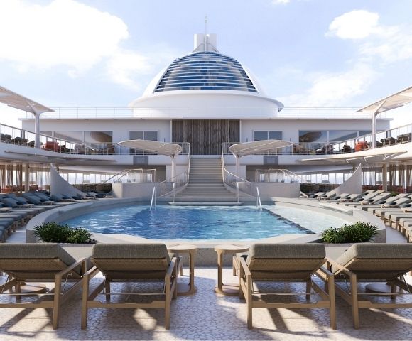An empty deck area of a cruise ship with a swimming pool, rows of lounge chairs, and a bar area.
