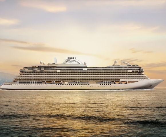 A large, modern white cruise ship sailing on calm ocean water with a golden sky and distant mountains.