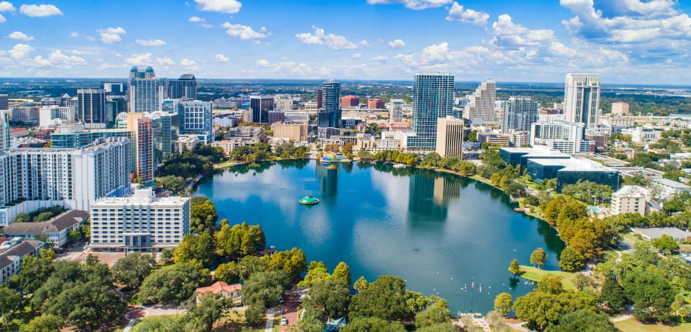 A vibrant skyline of Orlando, showcasing iconic attractions and a bustling atmosphere, popular among tourists.