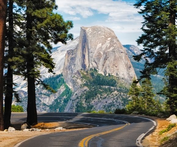 Half Dome and a winding section of Glacier Point Road in Yosemite National Park, California.