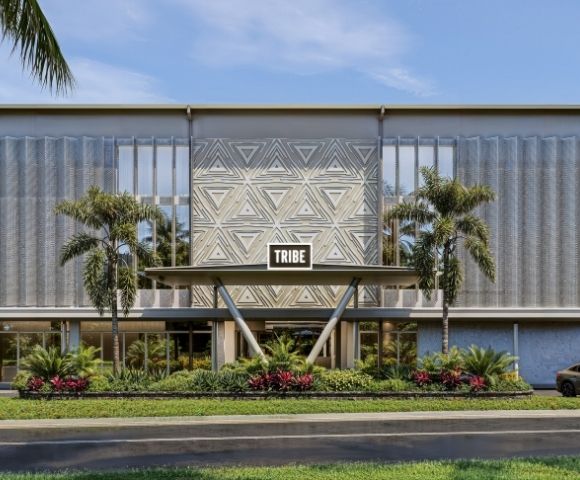 Modern building entrance with a triangular geometric pattern on the facade, a 