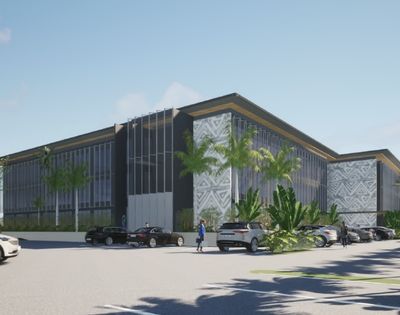 A modern architectural rendering of a multi-story office building with dark gray and white patterned facade elements, a dark roof with gold trim, and extensive floor-to-ceiling windows, set amidst lush palm trees and tropical foliage, with a paved parking lot in the foreground containing several parked cars.