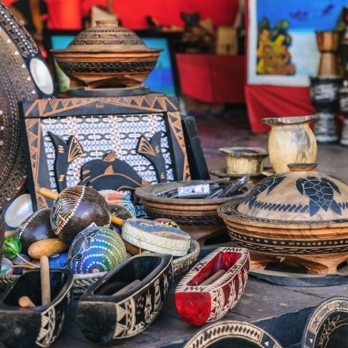 Colorful market display of Fijian carvings, creating a vibrant, artisanal atmosphere.