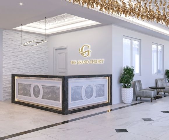 A sleek, modern reception area with a curved front desk featuring decorative paneling and ambient lighting, a textured wave-patterned wall, and the 