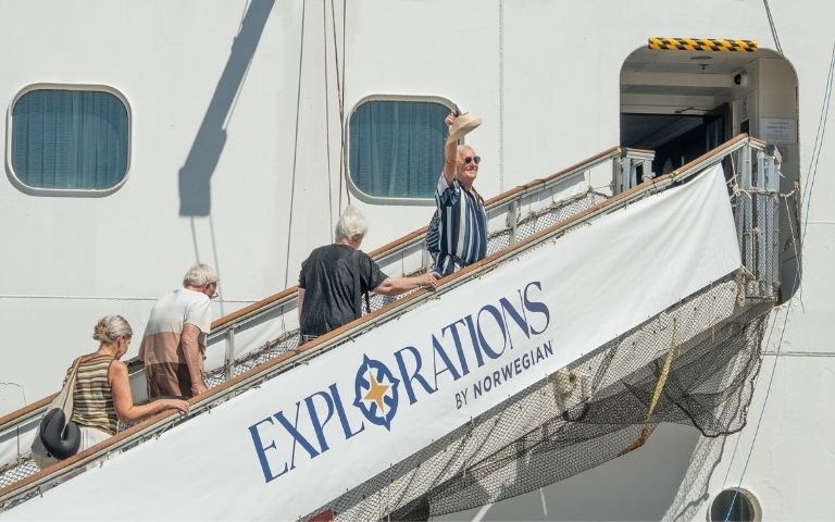 People boarding a cruise ship via a gangway with 