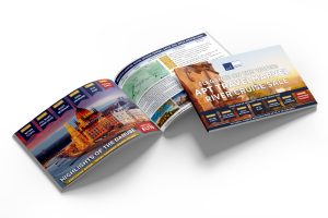 Open brochure on a white surface showing vibrant images of the Danube and a cruise ship. Cover headline reads, "APT Travelmarvel River Cruise Sale."