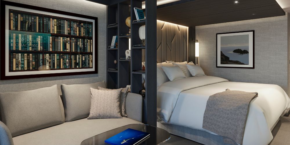 Elegant bedroom with a cozy sofa, bookshelf artwork, and a plush bed. Warm lighting and neutral tones create a serene, inviting ambiance.